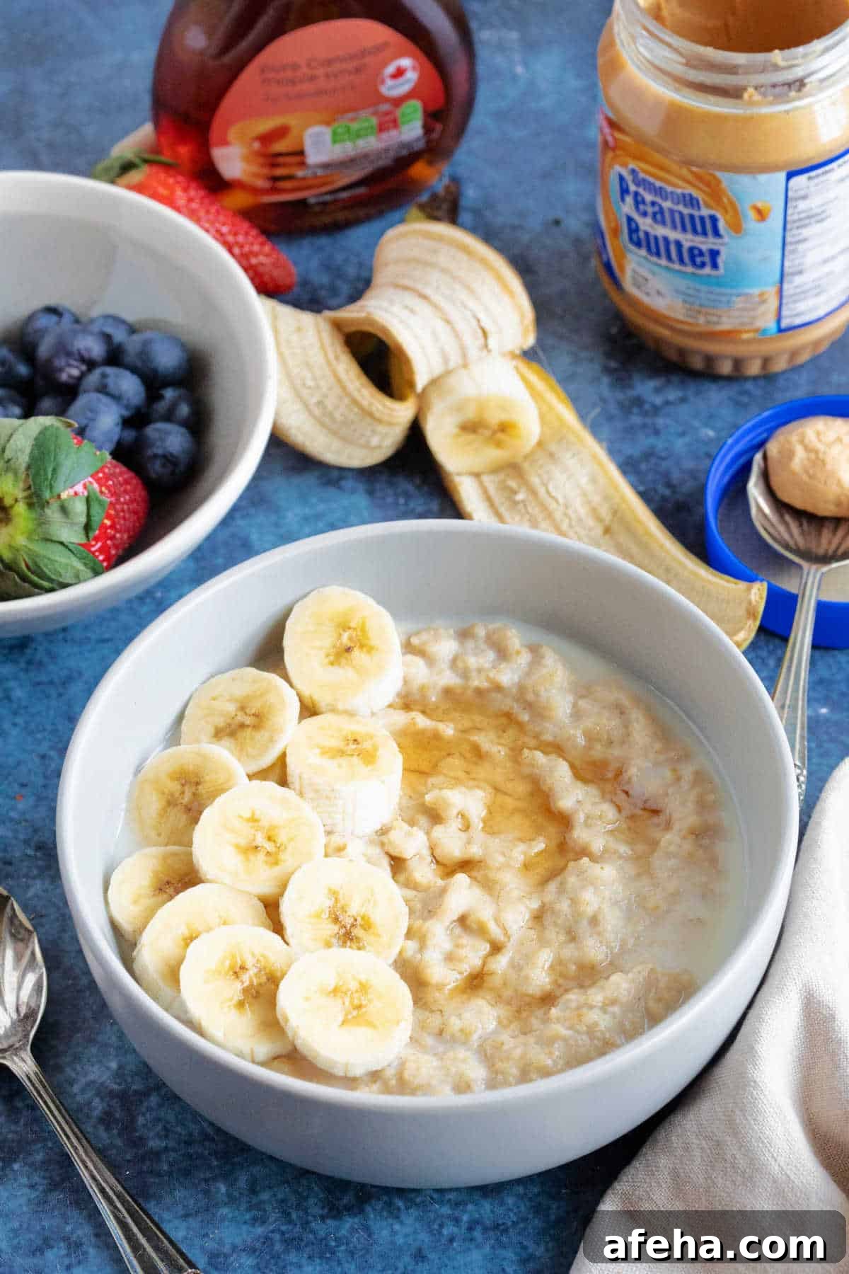 A bowl of peanut butter porridge with sliced banana.