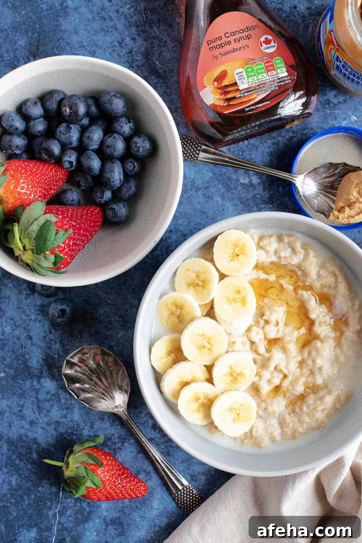 A bowl of peanut butter porridge with fresh berries.