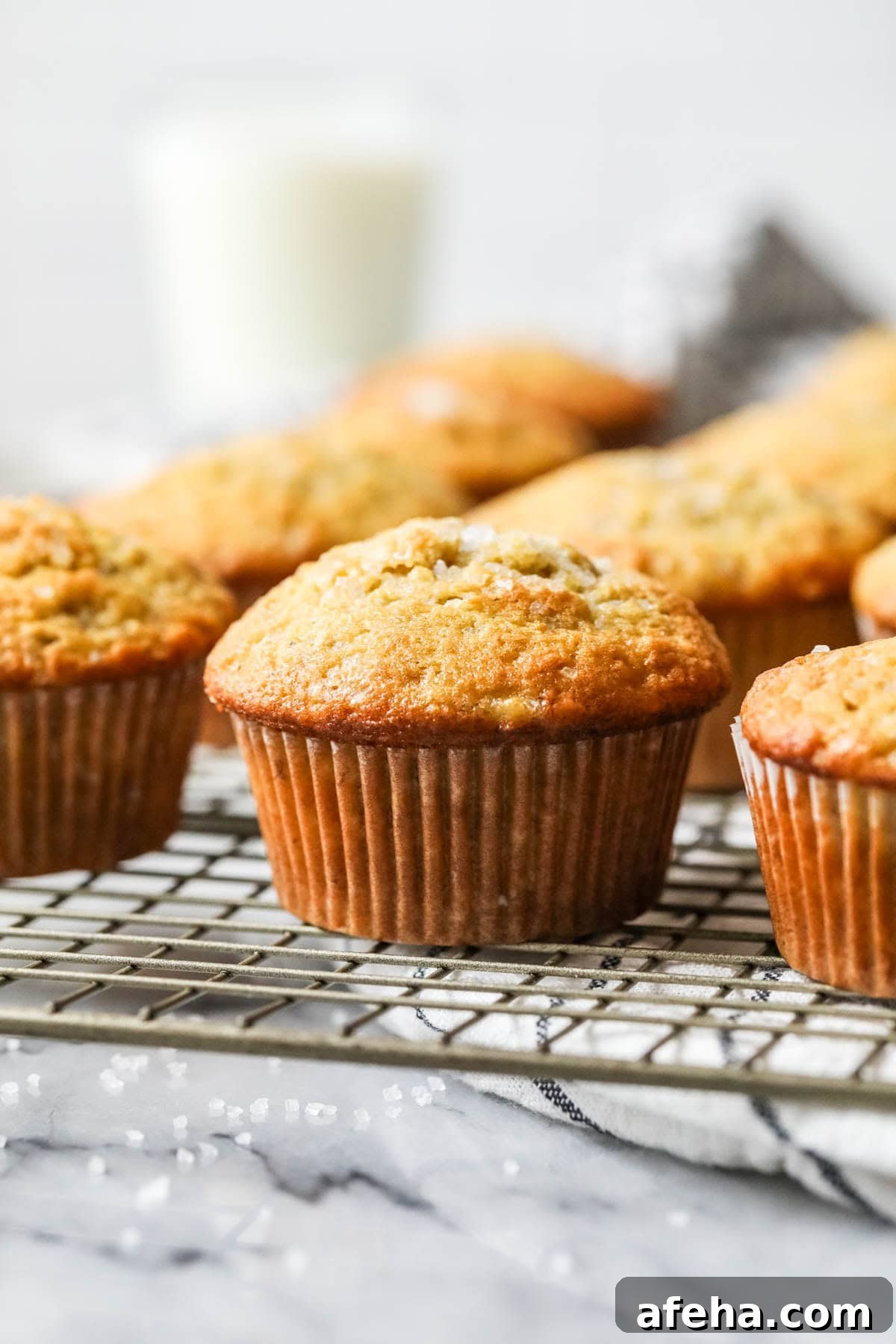 Rows of sourdough banana muffins on a cooling rack.