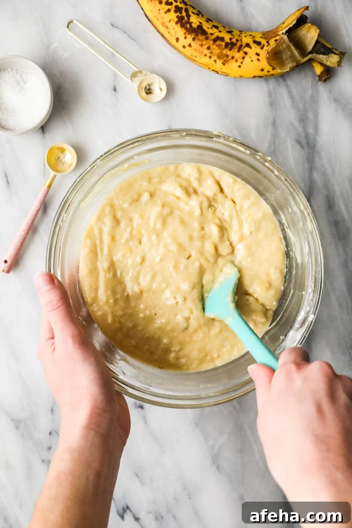 Overhead view of a bowl of banana muffin batter made with sourdough discard.