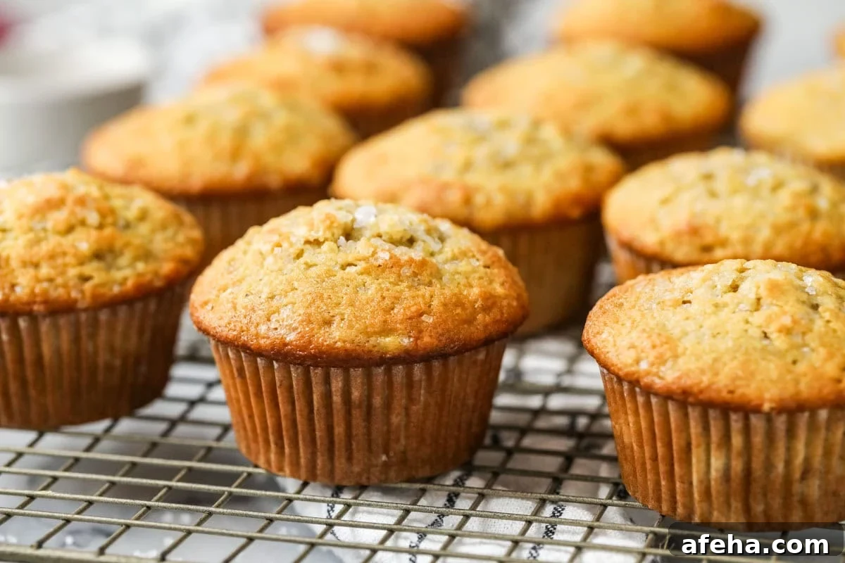 Rows of sourdough banana muffins on a cooling rack.