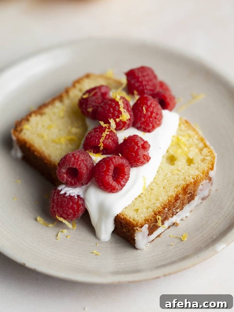 gluten free lemon loaf topped with greek yogurt and fresh berries, lemon drizzle cake