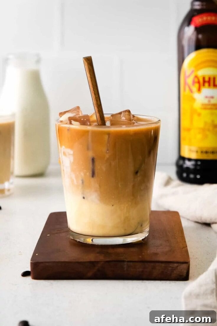 An eggnog white russian cocktail on a wooden serving board.