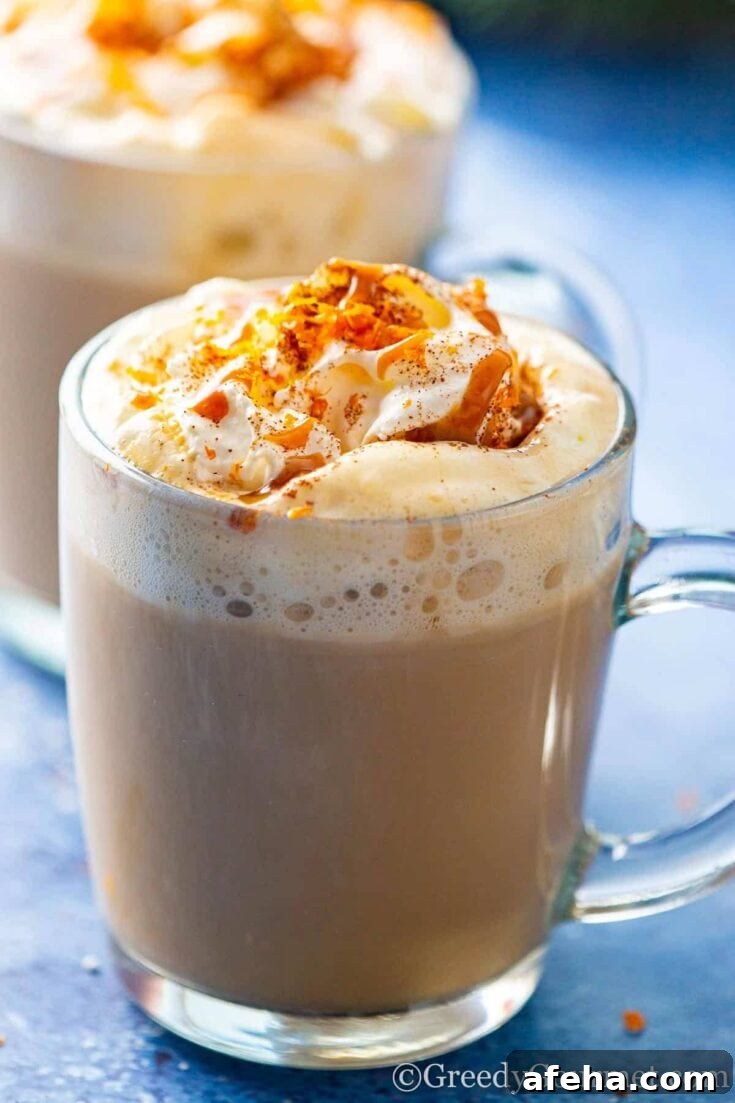 An eggnog latte topped with whipped cream and caramel sauce.