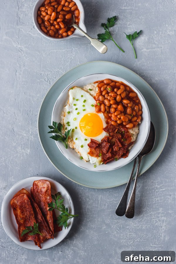 savory oatmeal topped with baked beans, egg and bacon