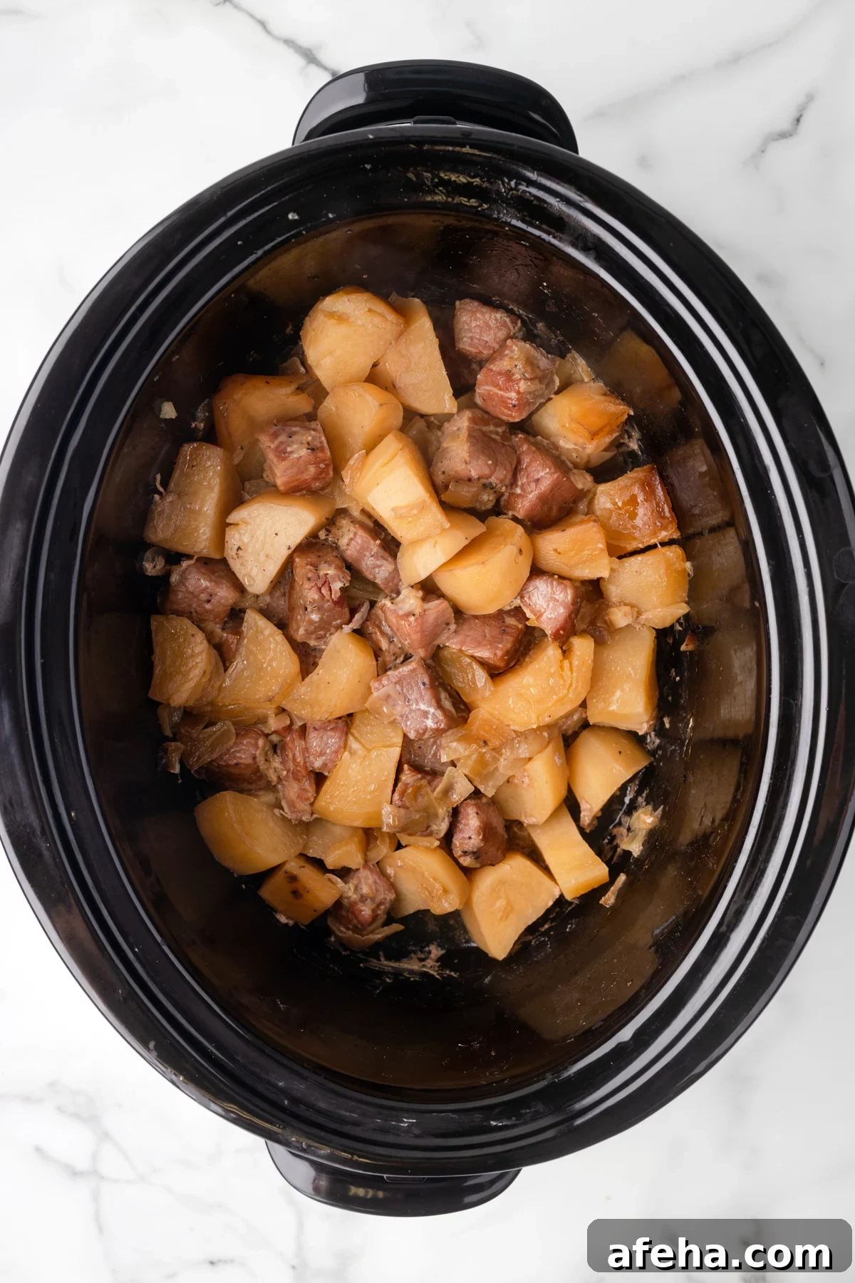 Corned beef and potatoes in a slow cooker.