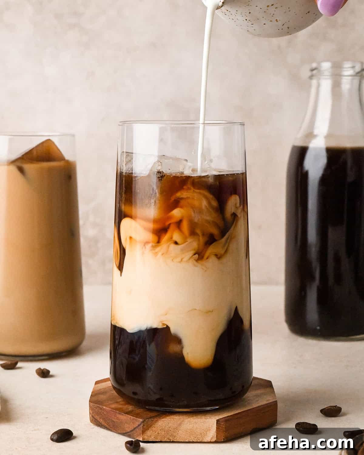 cream being poured into a glass of Cold Brew Coffee