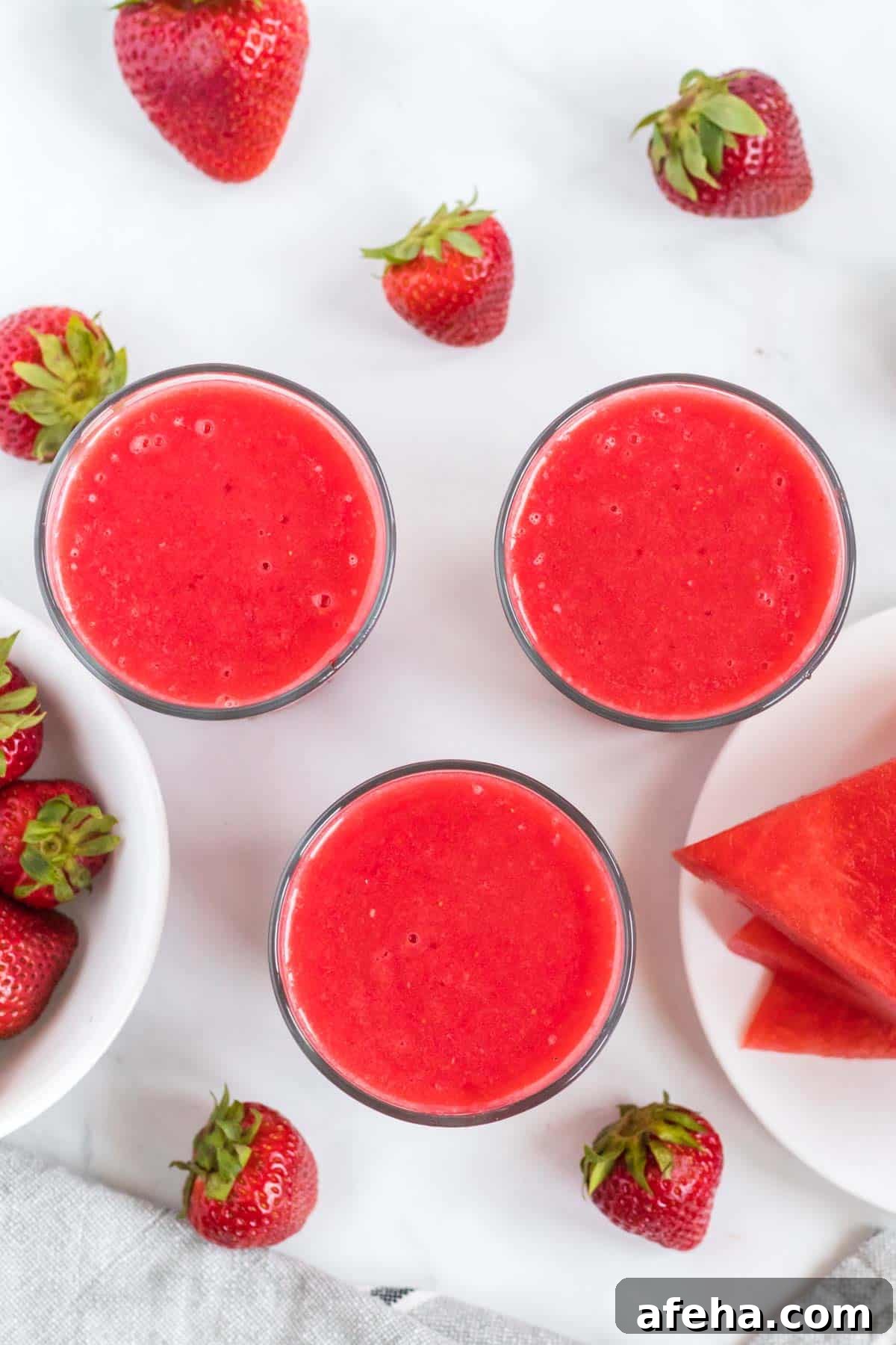 3 watermelon strawberry smoothies from an overhead view