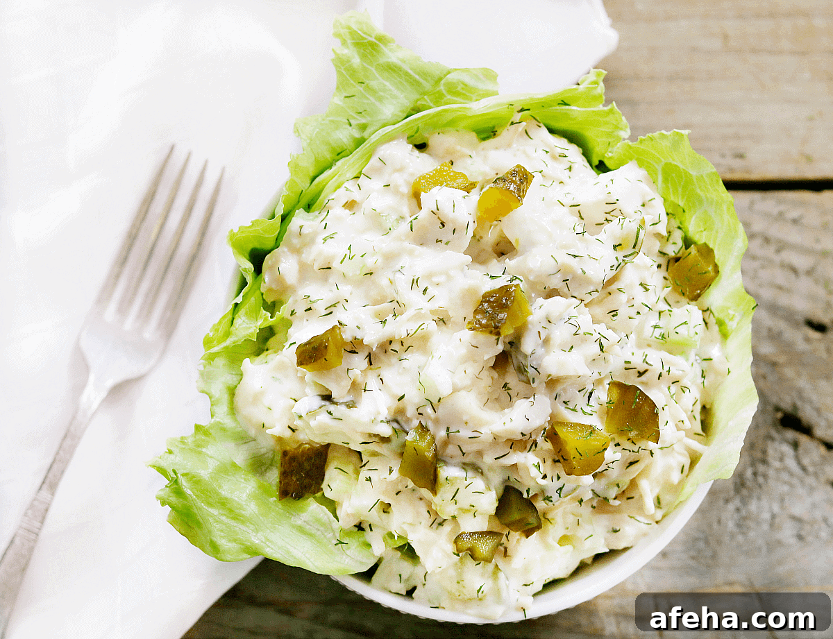 scoop of dill pickle chicken salad in white bowl.