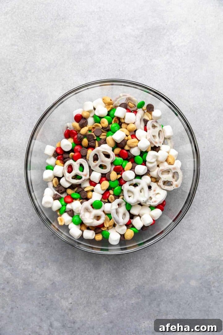 Christmas Trail Mix: Sweet and Salty Holiday Snack Recipe 4 Top down view of snack mix in a glass bowl.