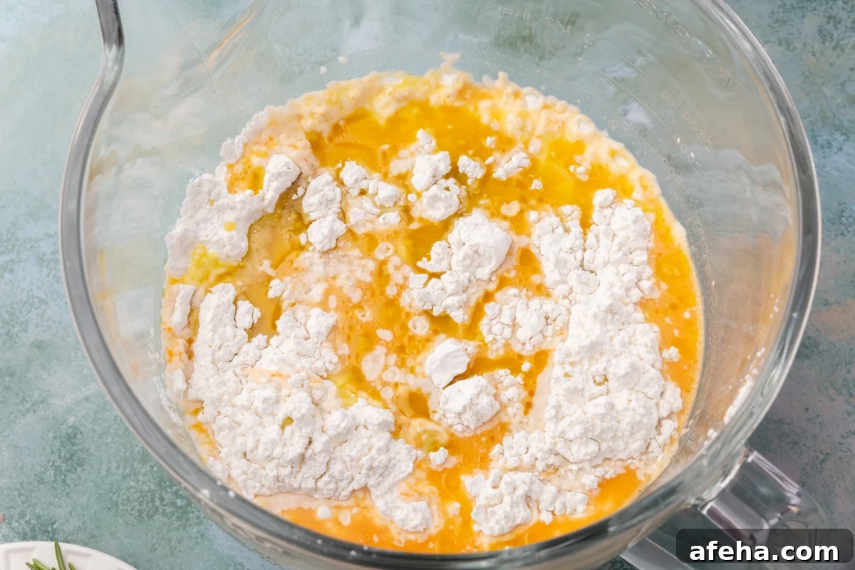 Mixing bowl with pumpkin puree, water, olive oil, and gluten-free flour for pumpkin focaccia.