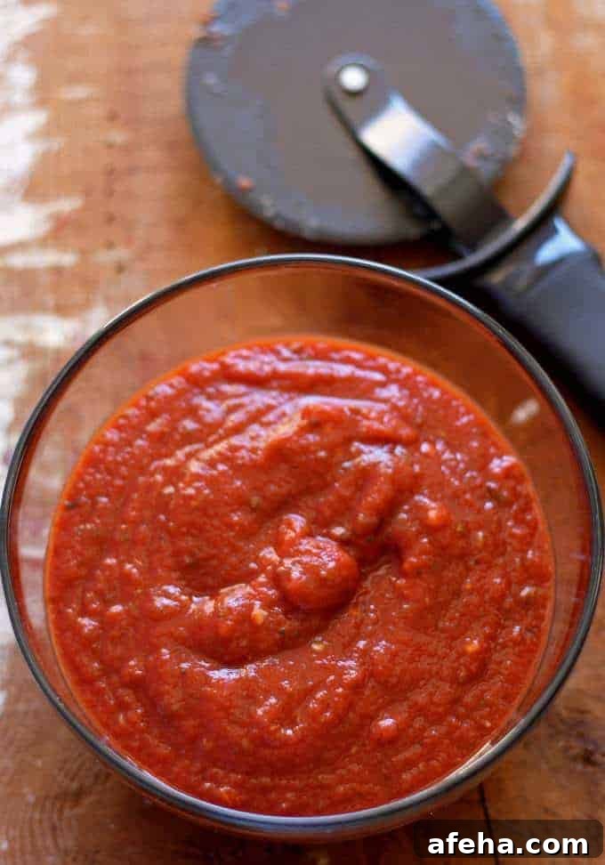homemade pizza sauce and a pizza cutter