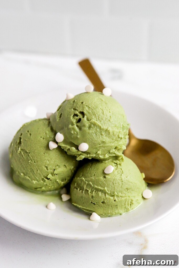 Ninja Creami Matcha Ice Cream: 48g Protein 3 Matcha protein ice cream in a white bowl with a gold spoon