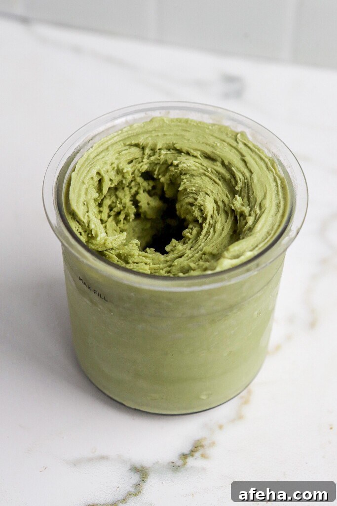 Ninja Creami Matcha Ice Cream: 48g Protein 5 Ninja Creami matcha protein ice cream in the pint, side angle