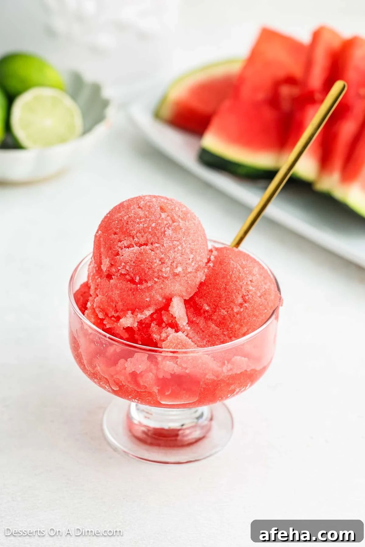 Watermelon sorbet in a bowl with a spoon.