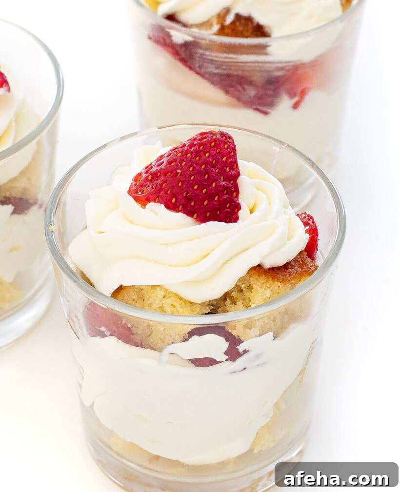 Mini strawberry shortcake assembled in a clear glass.