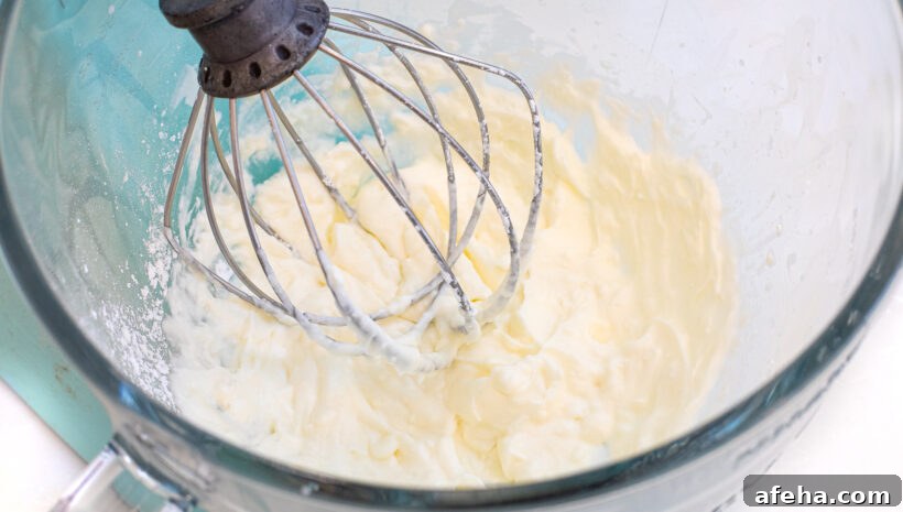 whipped cream in stand mixer with the whisk attachment