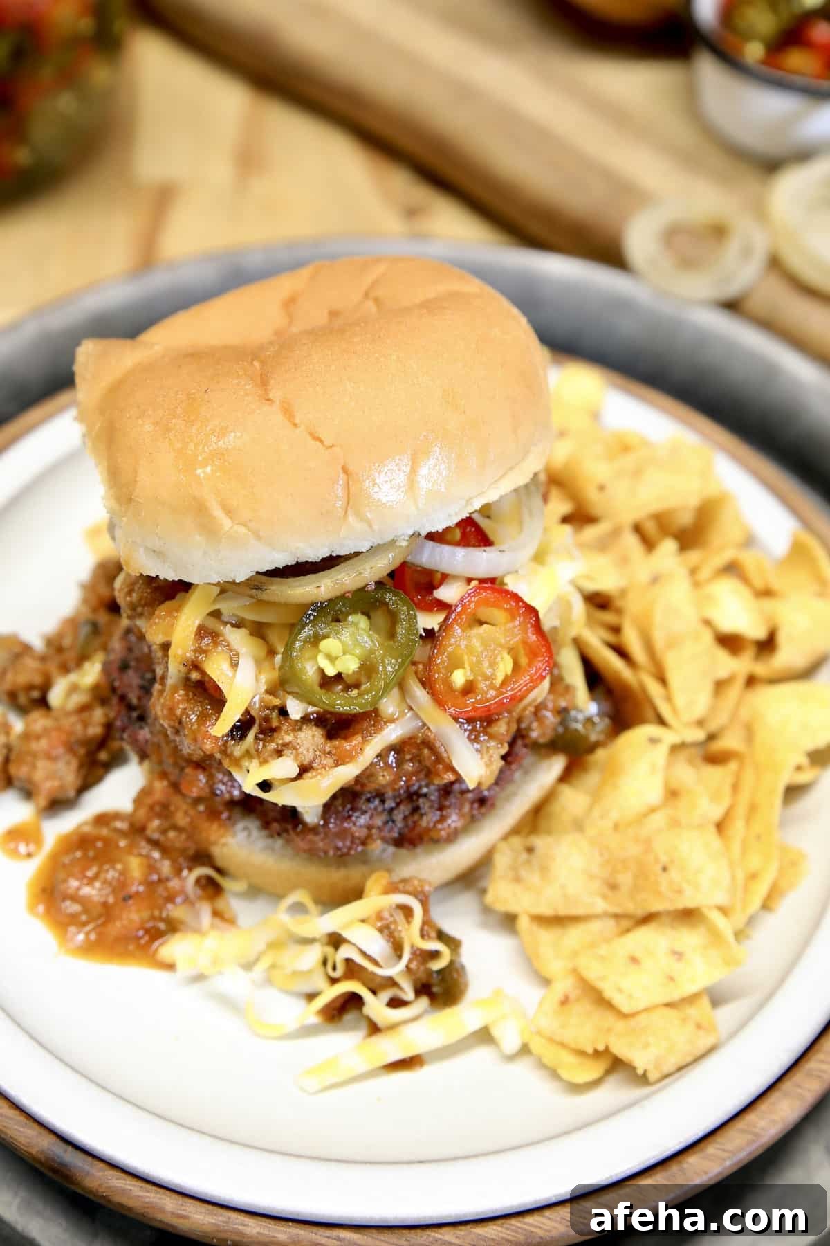 Plate with chili cheese burger and fritos.
