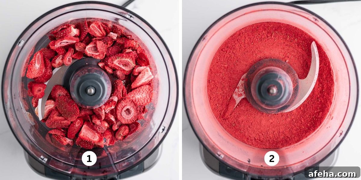 Processing freeze dried strawberries into a fine powder in a small food processor on a white background.