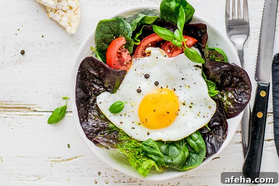 salad topped with poached egg on a plate