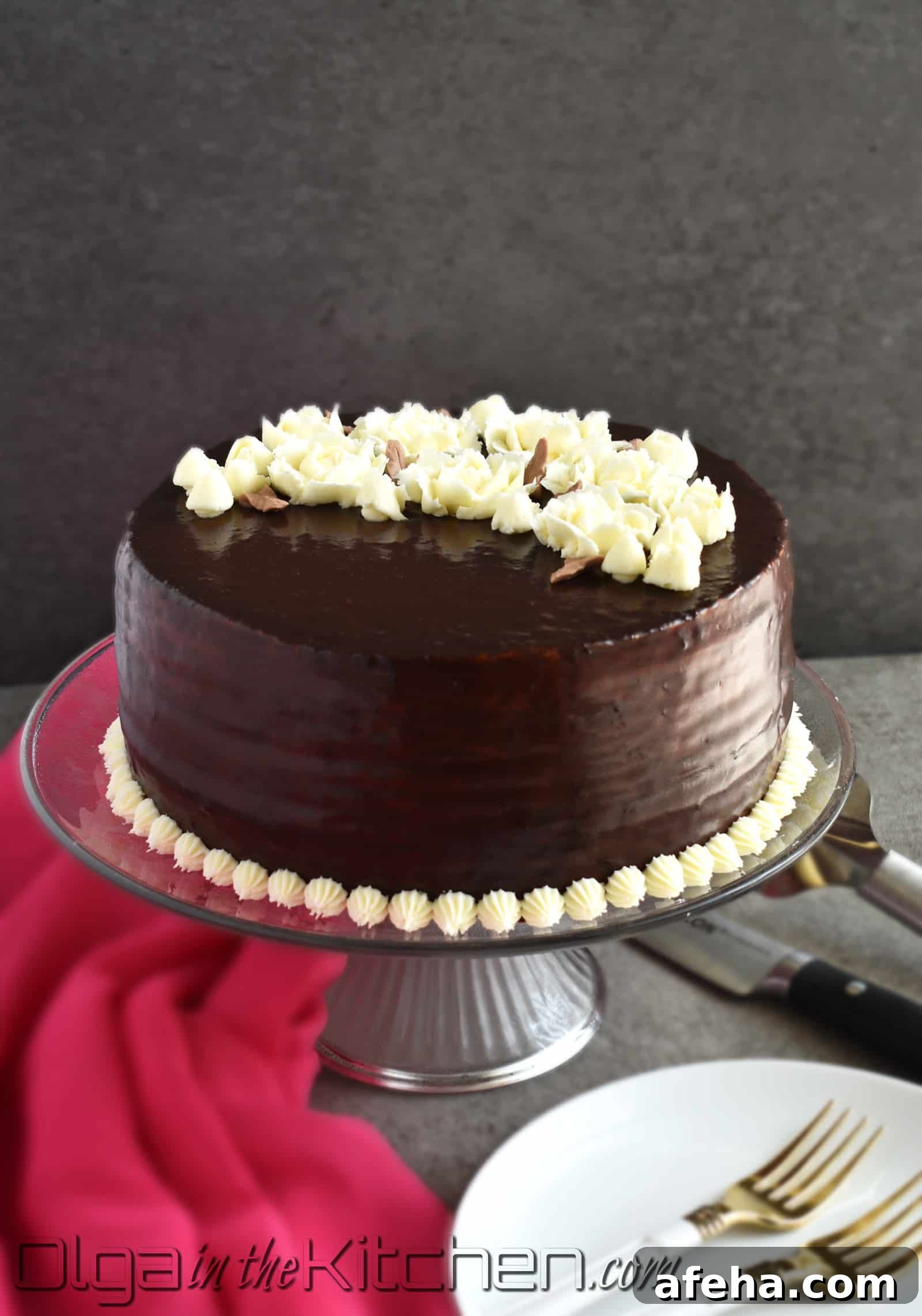 Chocolate Spartak Cake: chocolate-y, 9-layer cake, filled with sour cream frosting, topped with chocolate ganache and decorated with buttercream flowers! | olgainthekitchen.com