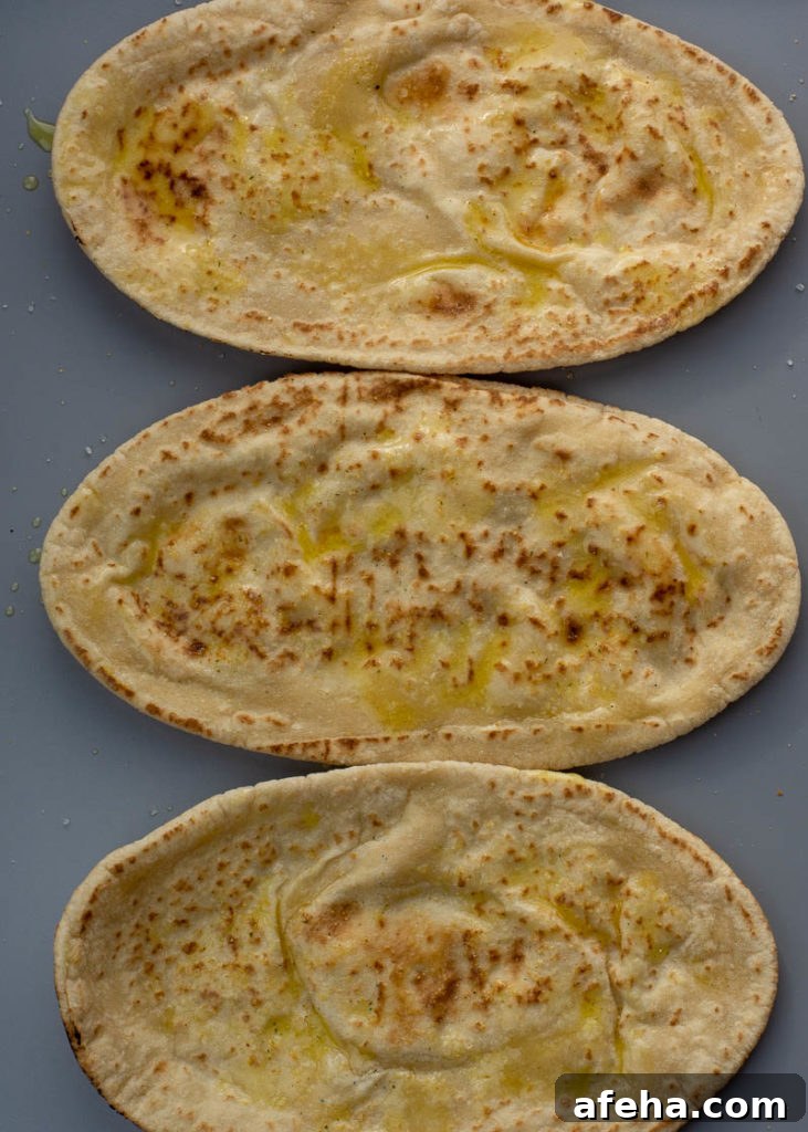 Brushing olive oil on pita before air frying