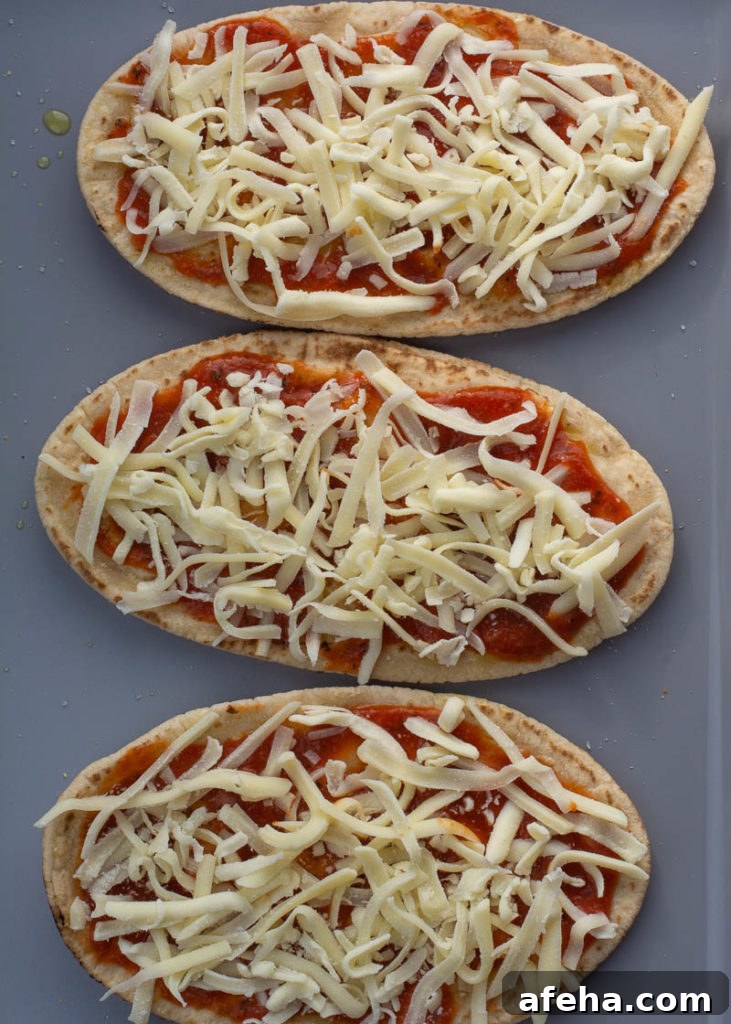 Pita pizza topped with cheese and pepperoni