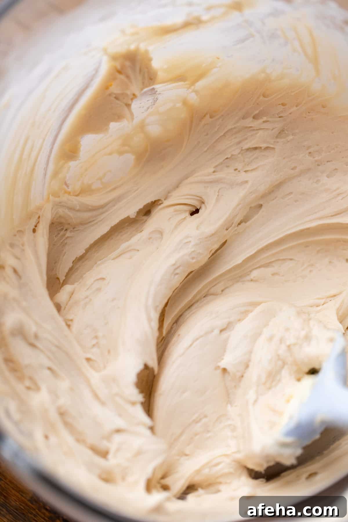 Maple cream cheese frosting in a glass bowl.