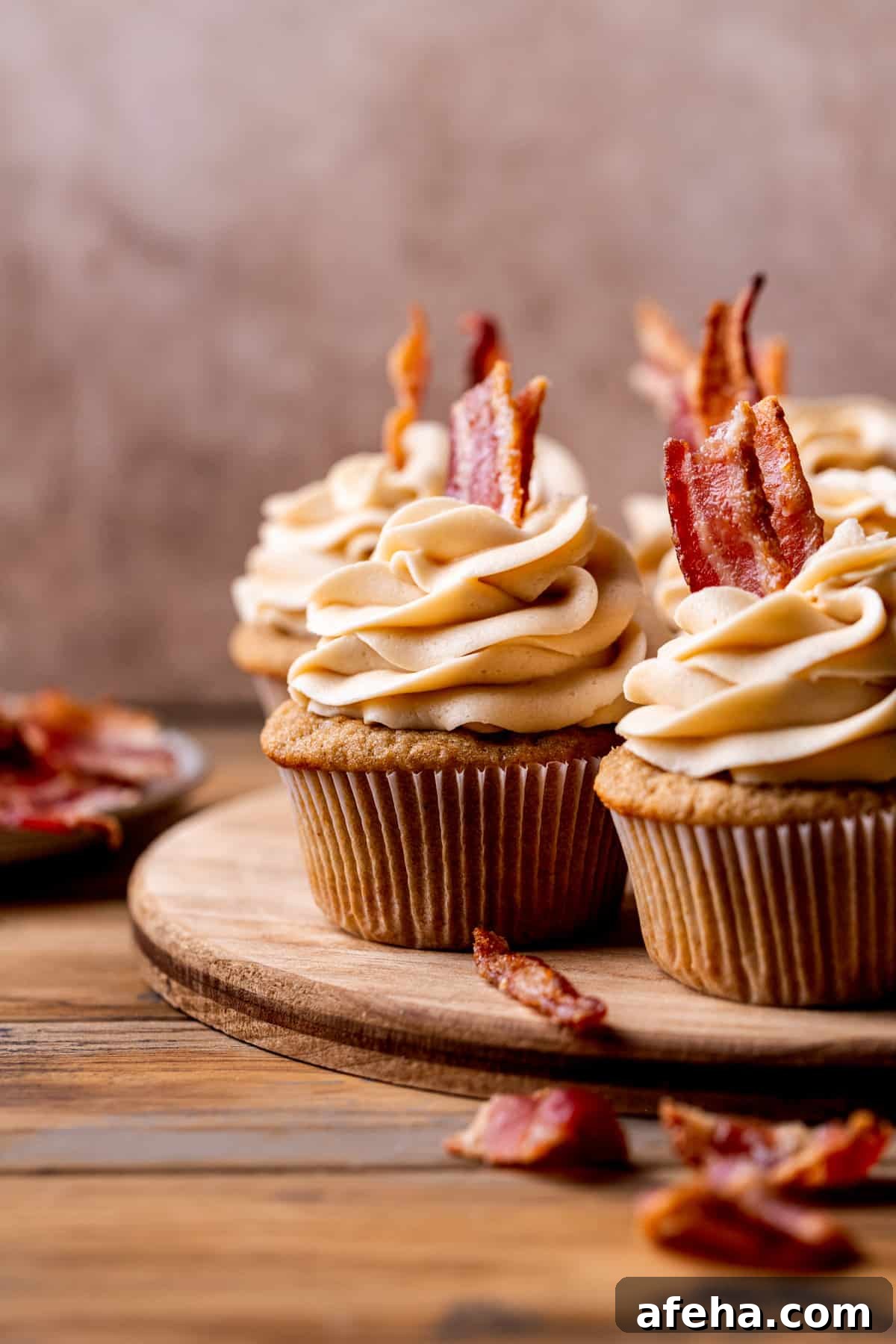 Decorated cupcakes on a wood board.