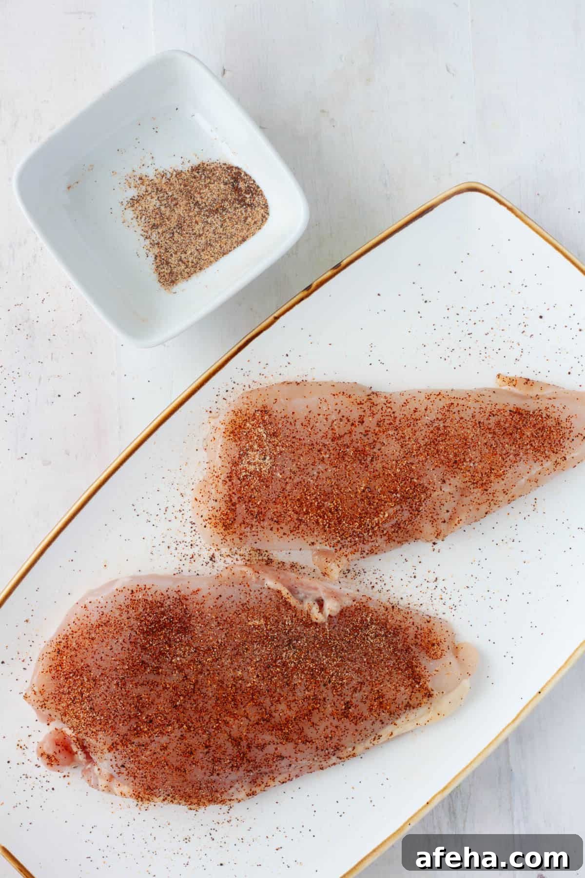 Cast Iron BBQ Chicken Breast Recipe 4 Chicken breasts sprinkled with a spice rub.