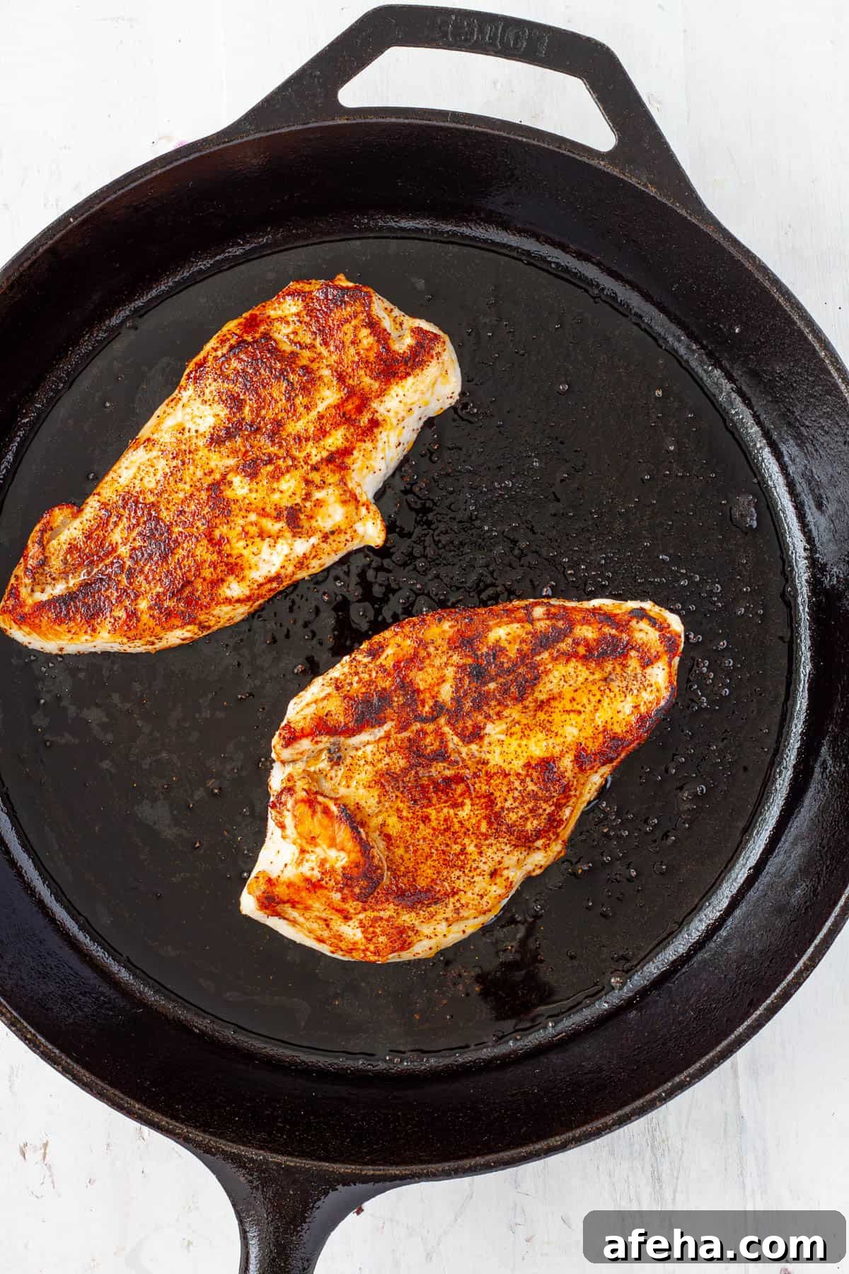 Cast Iron BBQ Chicken Breast Recipe 5 Chicken breasts seared in a cast iron skillet.