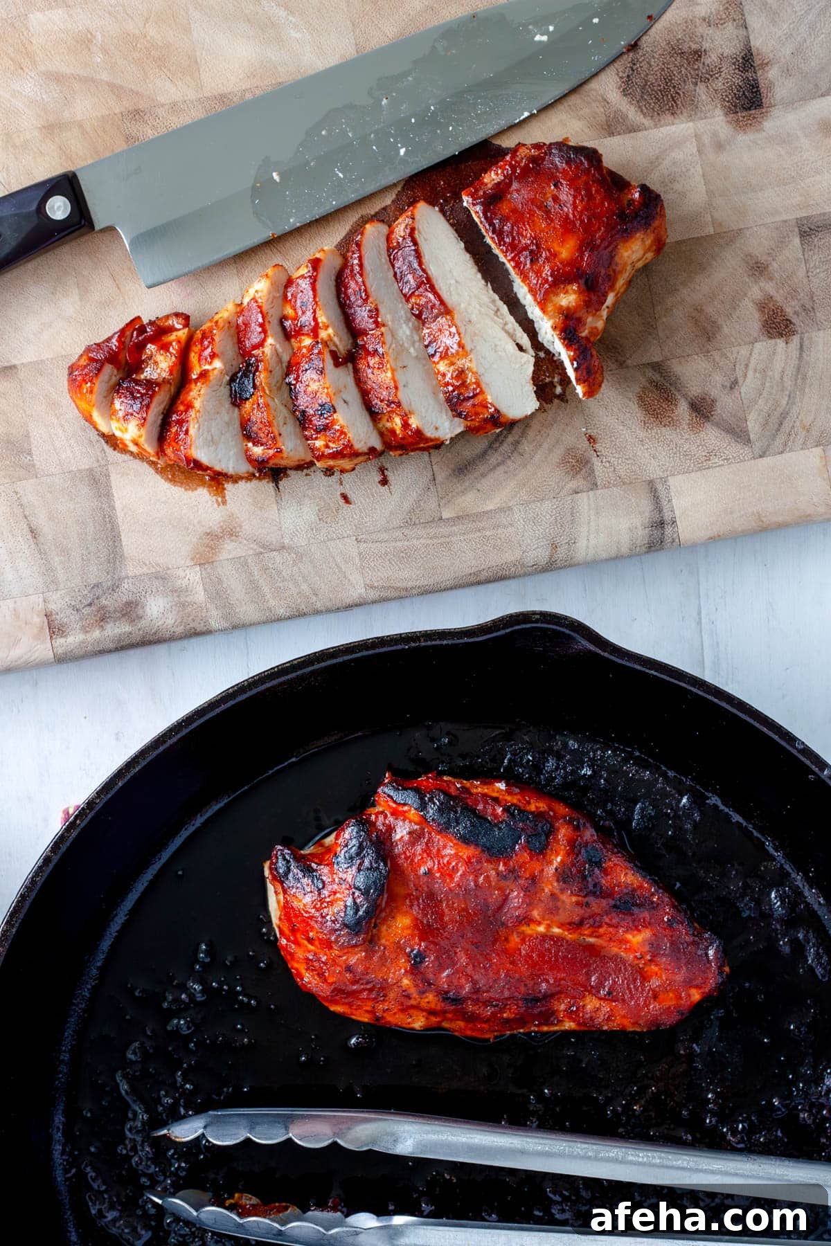 Cast Iron BBQ Chicken Breast Recipe 9 A bbq chicken breast getting sliced on a cutting board with another still in a cast iron skillet