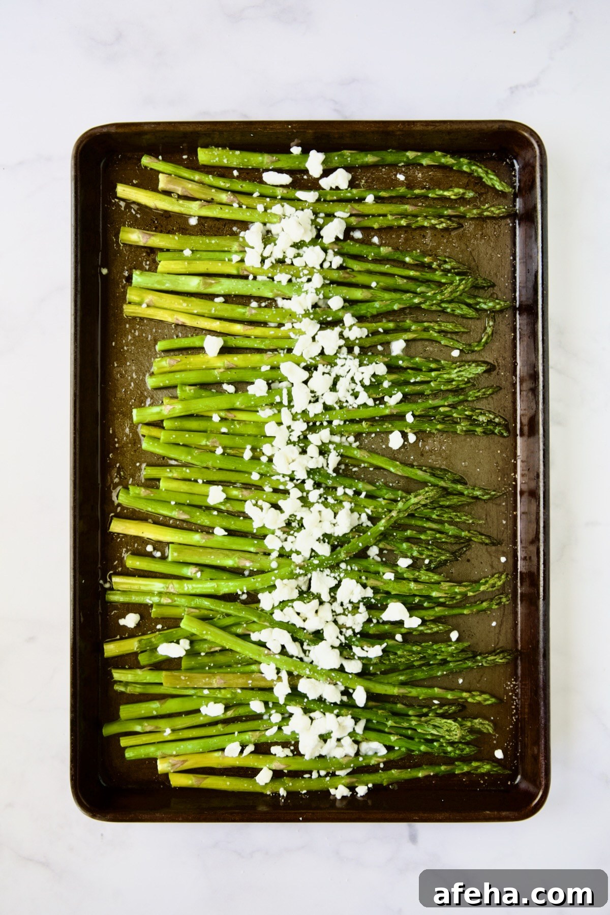 Roasted asparagus sprinkled with goat cheese.